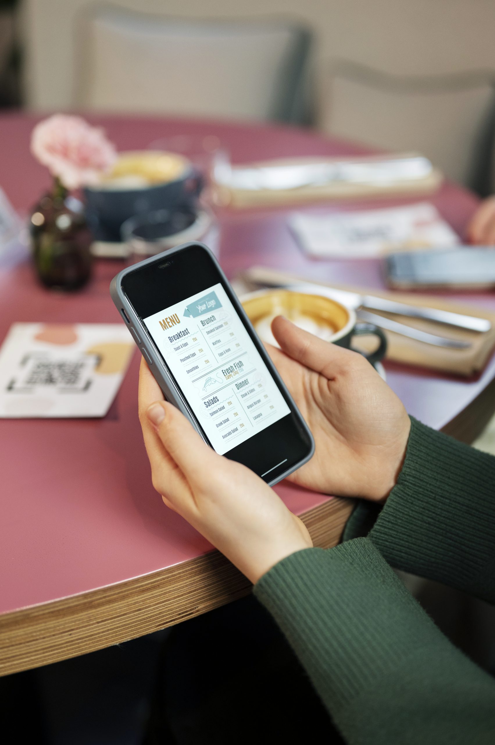high-angle-hands-holding-phone-with-menu