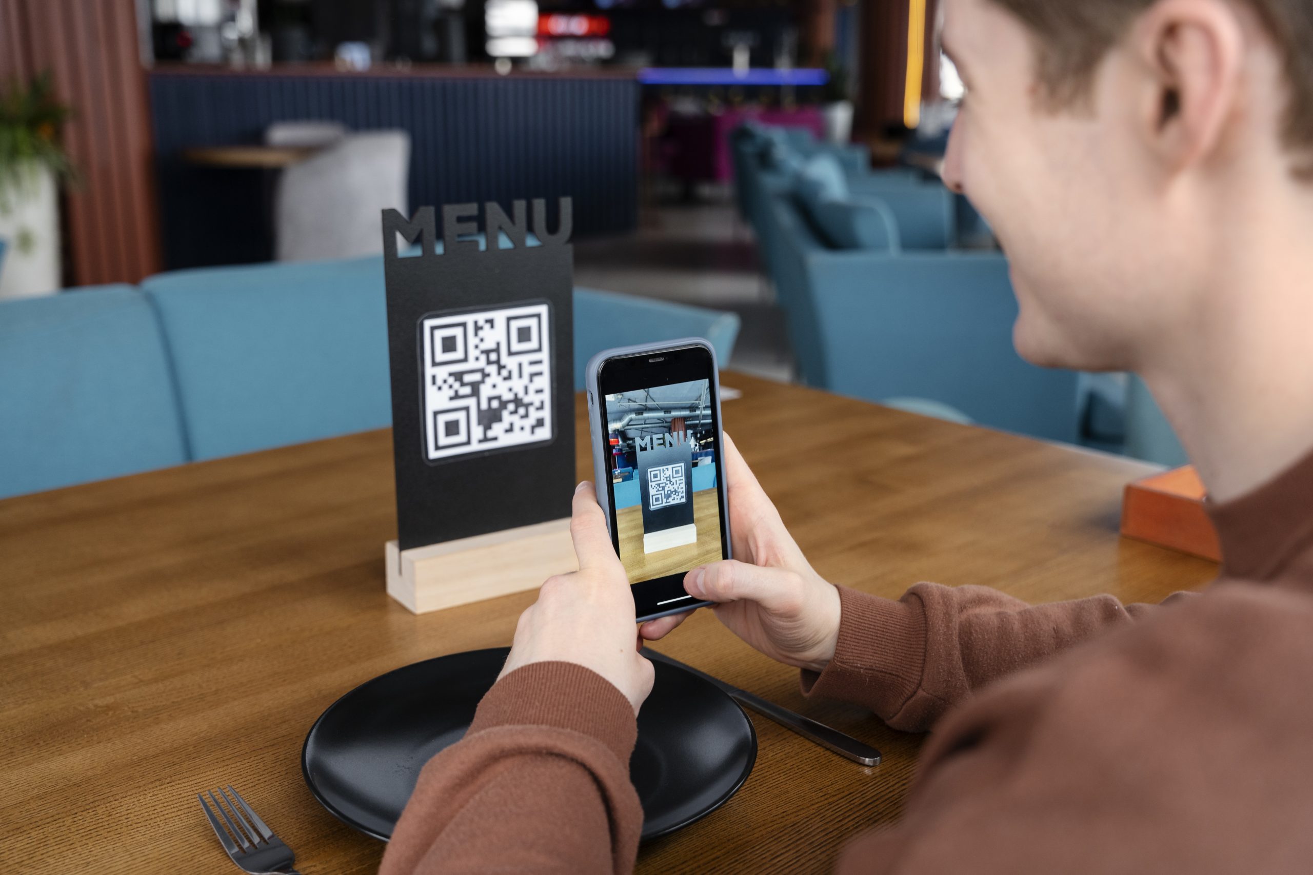 Someone scanning a QR code at a restaurant.