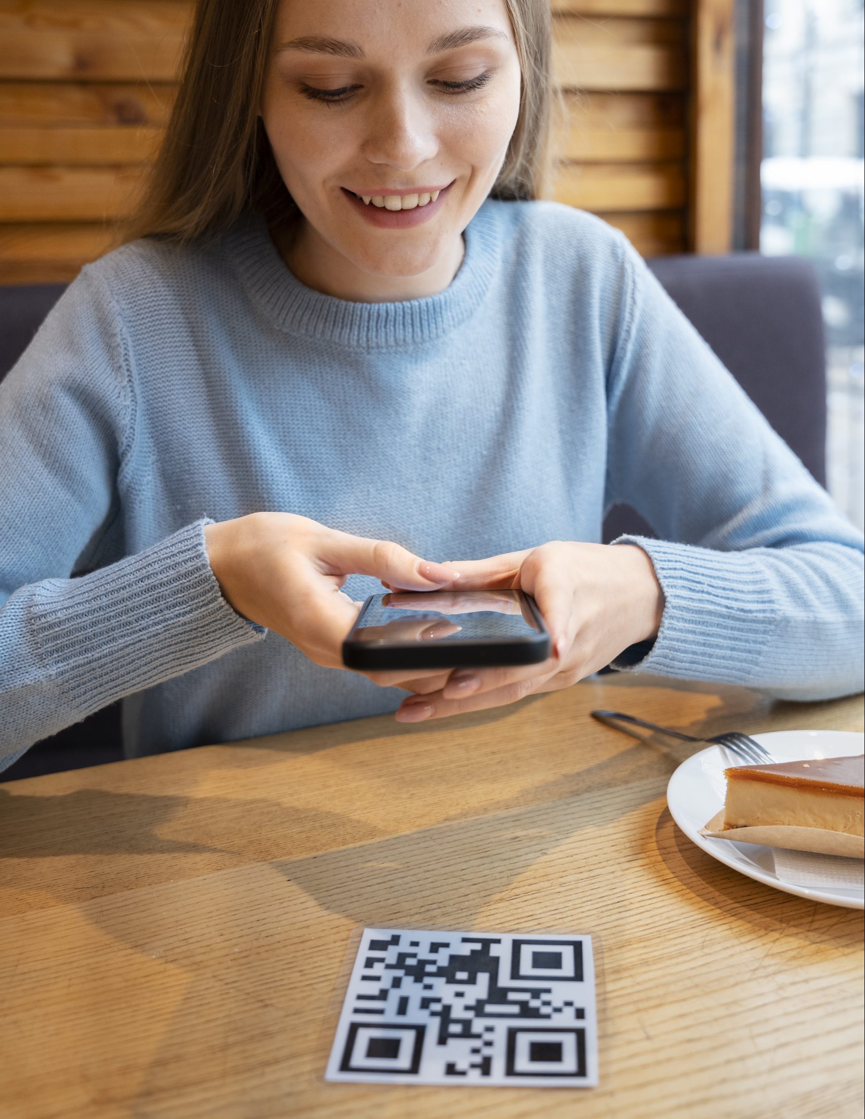 someone scanning a QR code at a restaurant