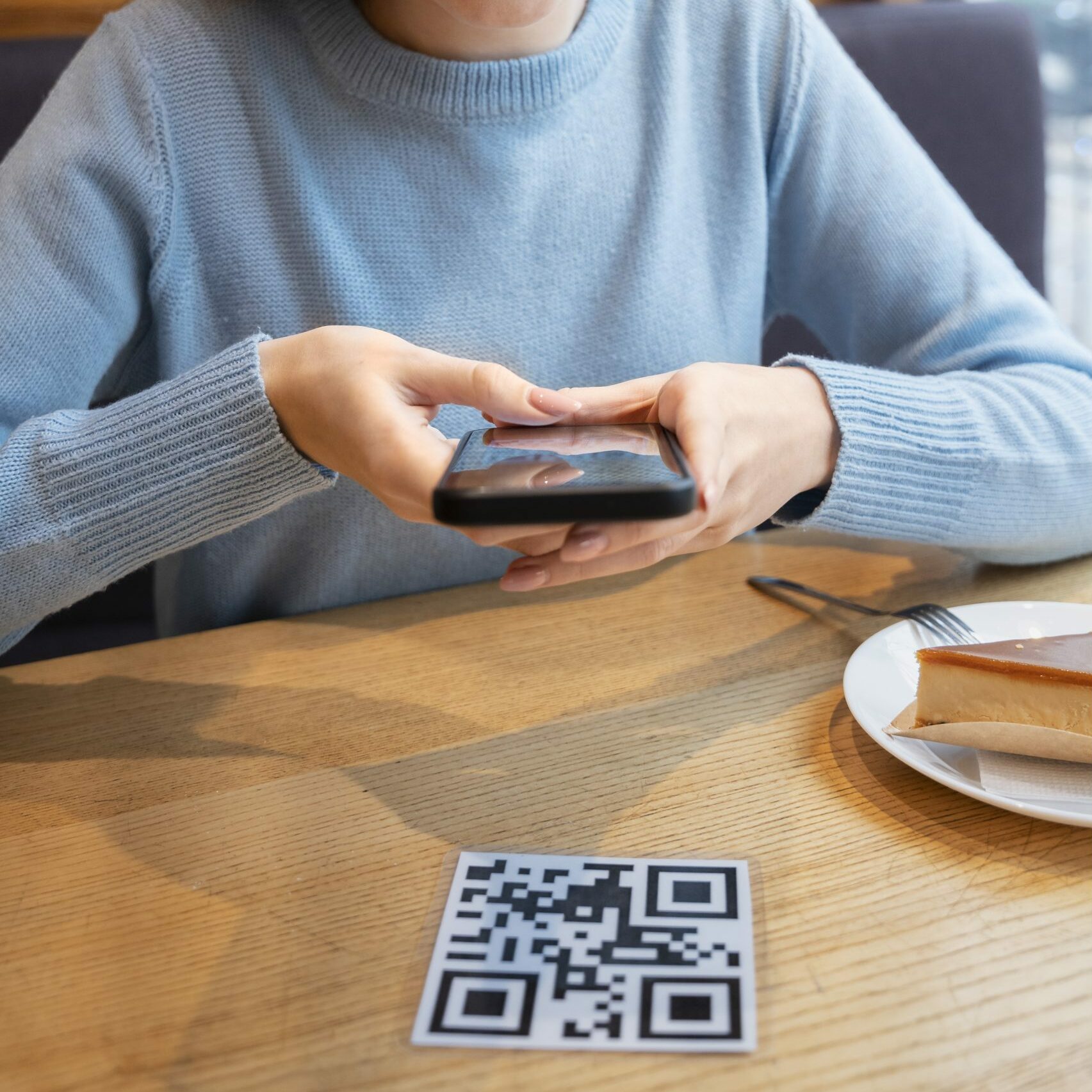 someone scanning a QR code at a restaurant