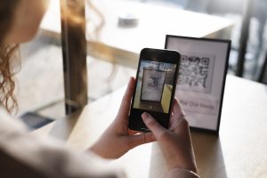 person scanning a QR code at a restaurant