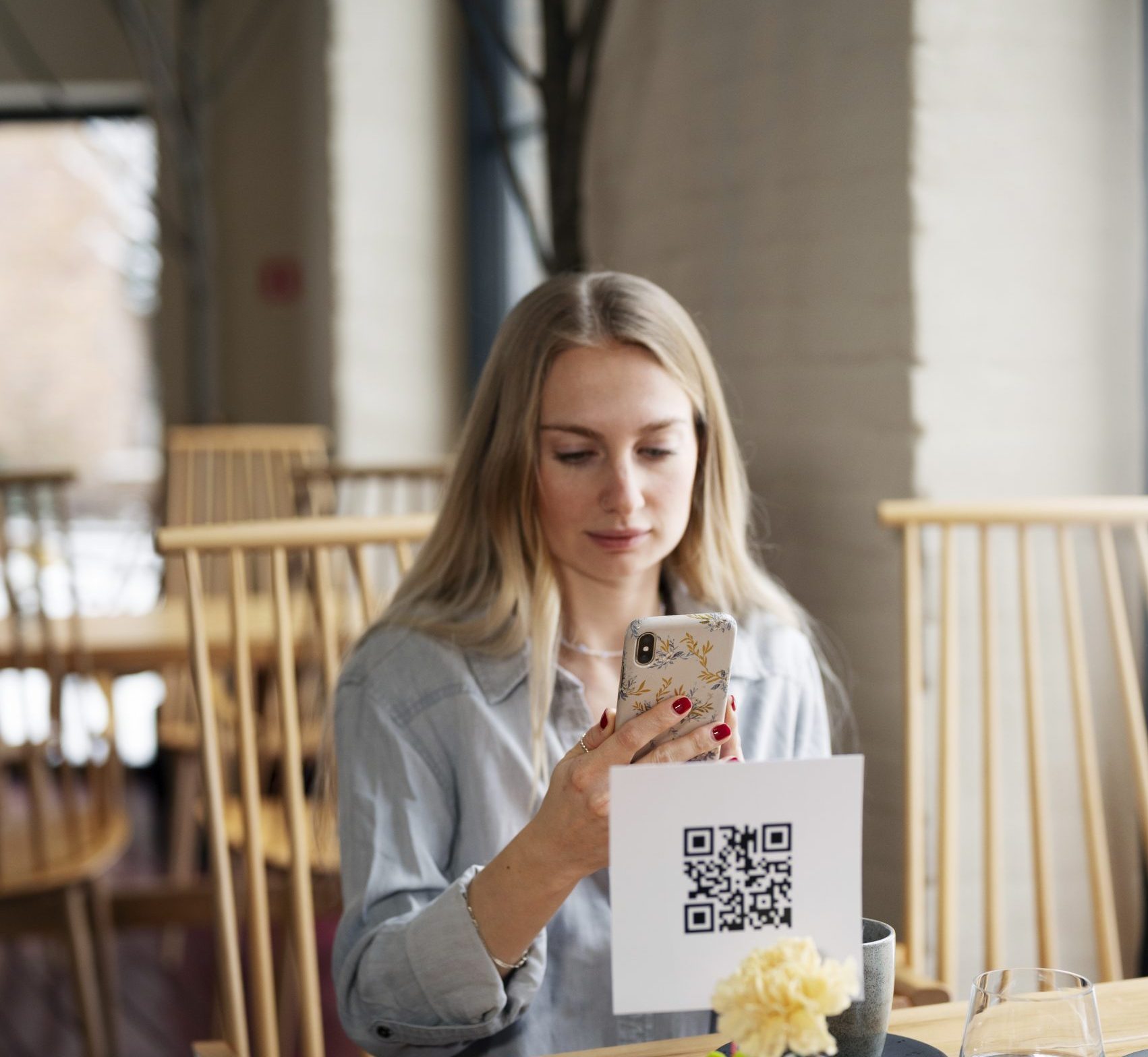 Woman scanning a qr code at the restaurant.