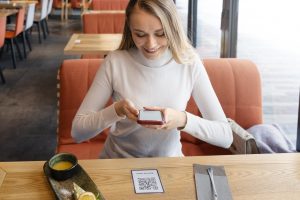 woman-scanning-qr-with-phone-medium-shot