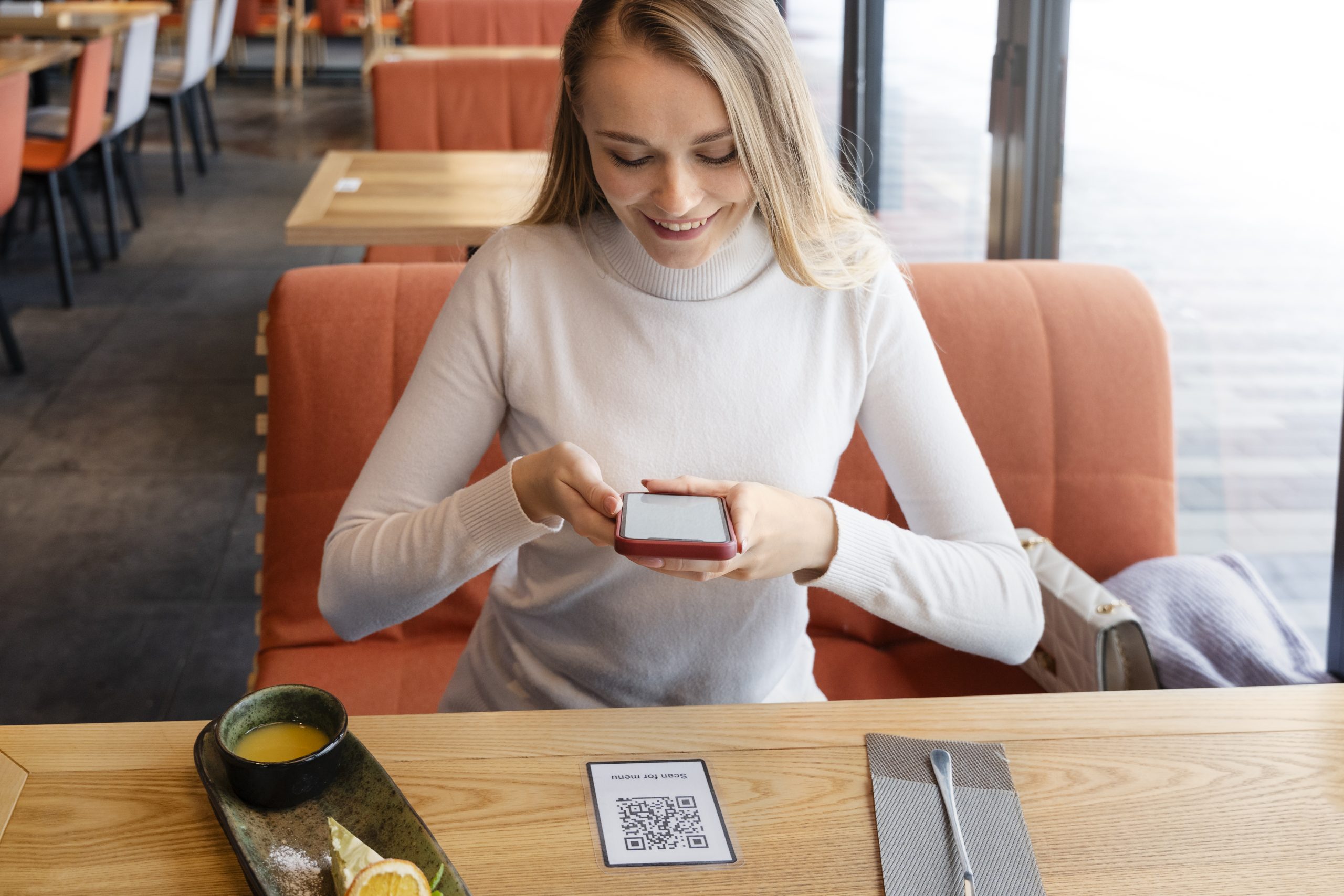 Someone scanning a QR code at a restaurant