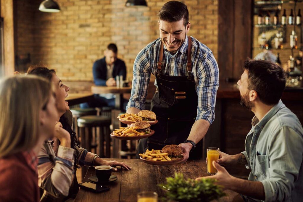 A waiter serving customers