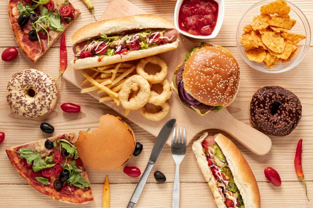 All types of fastfood scatered on a table