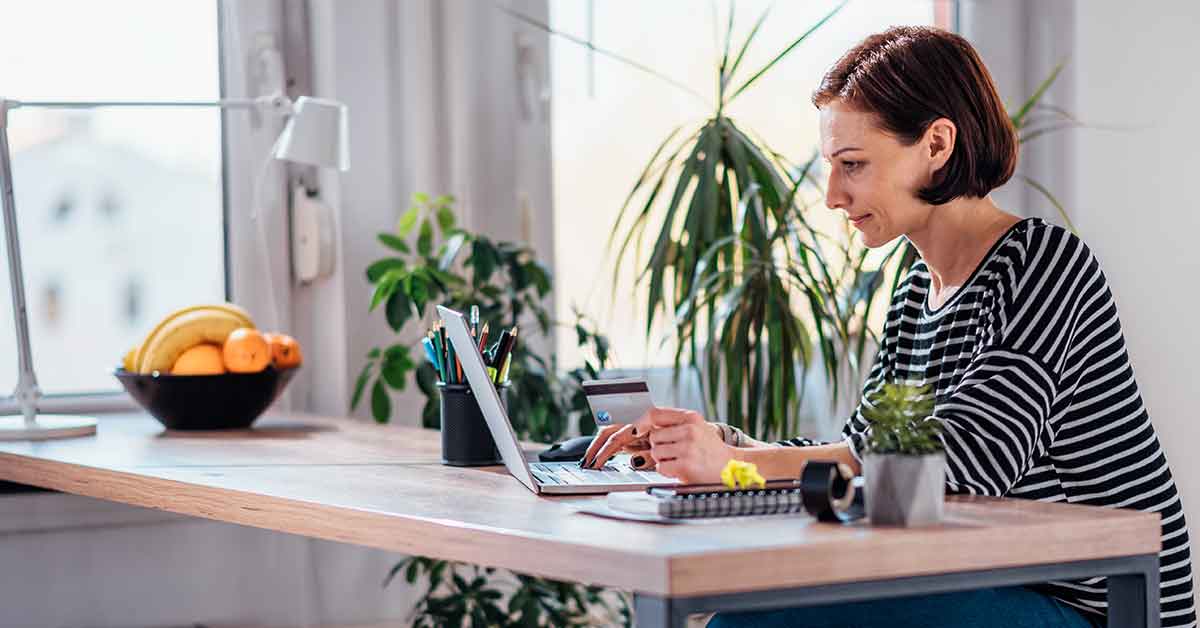 woman shopping online using credit card