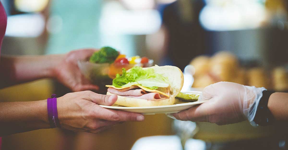 closeup shot personserving sandwich white plate